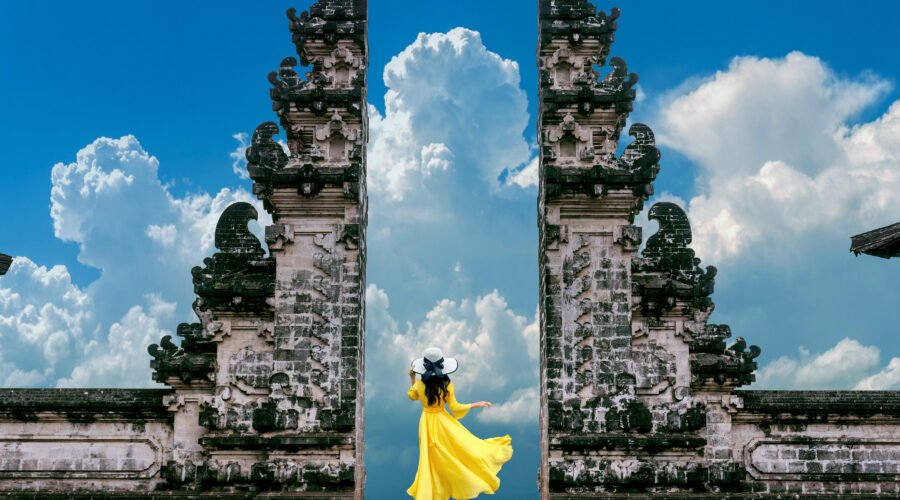 Young woman standing in temple gates at Lempuyang Luhur temple i